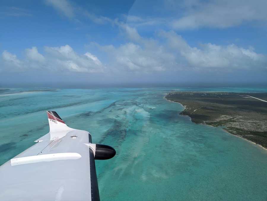 TBM 900 over turquoise Bahamas water